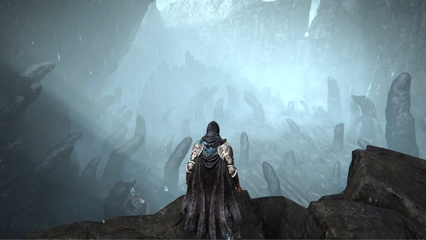The player in Elden Ring: Shadow Of The Erdtree stands on a cliff looking down into the Finger Ruins Of Rhia.