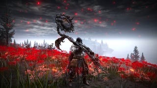 The player in Elden Ring: Shadow Of The Erdtree stands in a field of vibrant red flowers and holds a gigantic black sunflower weapon above their head.